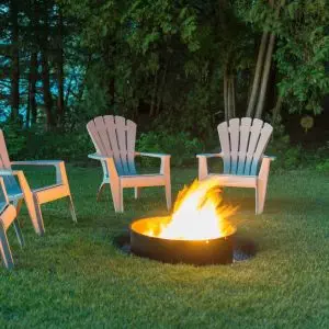 A fire pit in a grassy area.
