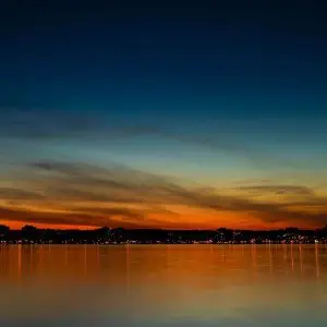 A sunset over a body of water. A sunset over a body of water.