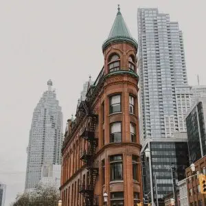 A building with a clock tower in the middle of a city. A building with a clock tower in the middle of a city.